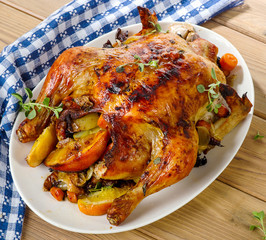 Homemade  Whole Chicken on a white plate.