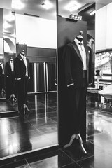 Wedding dress shop, black suit from side view for groom and men, black and white vertical
