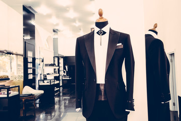 Dress shop with black suit for groom and men on model in showroom, vintage