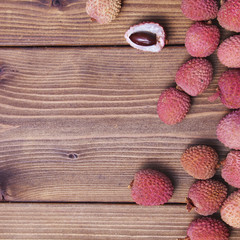 Wooden background with lychee fruits