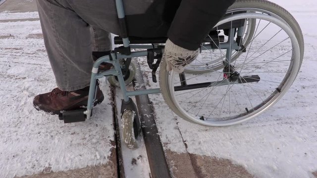 Disabled man on wheelchair stuck on railway