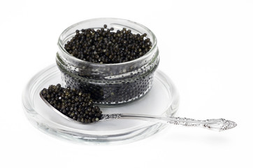 Fototapeta na wymiar Spoon and Bank with black caviar on glass saucer isolated on white background
