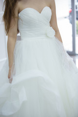 Fototapeta na wymiar Bride white wedding dress, shallow focus, tulle cloth vertical