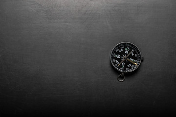 Compass on black board background