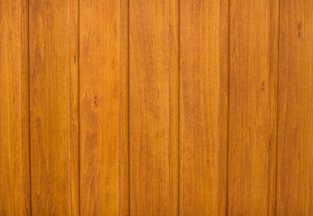 Natural wooden orange background, rough texture of hardwood planks for floors and walls in the construction of the house