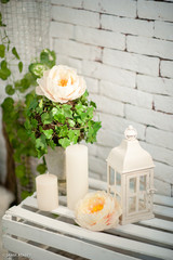 Decoration with white lantern and green, white flowers for wedding, vertical
