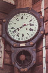 Old collection of the rusty metal wall clock on a grunge wood pillar house. (vintage style)