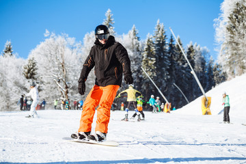 Snowboarder skating in the mountains with deep blue sky