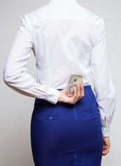 Unrecognizable businesswoman hiding dollars