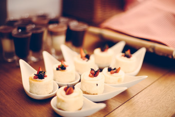 Setting of the table with food for breakfast, sweet, desserts menu in hotel, cafe,  vintage