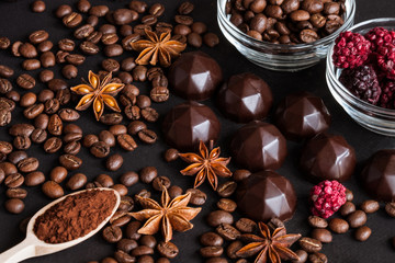 Chocolate sweets, coffee beans, dry raspberries background