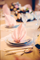 Elegant table setting with beautiful flowers and napkins, vertical vintage