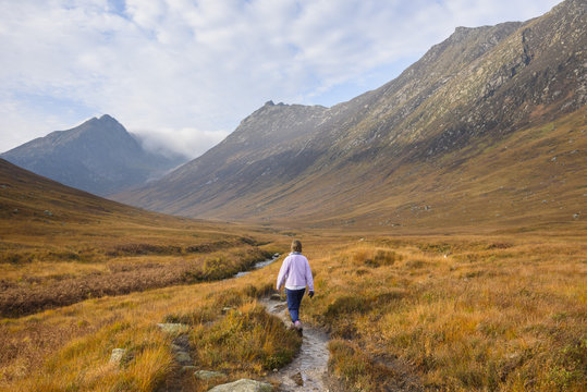 Woman walking in Glen Sannox, Isle of Arran, North Ayrshire, Scotland