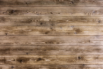 Fototapeta na wymiar Natural wooden brown background, rough texture of hardwood planks for floors and walls in the construction of the house