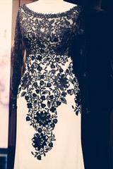 White long evening dress with black lace details, shallow focus, vertical vintage