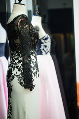 White long evening dress with black lace details, shallow focus, vertical