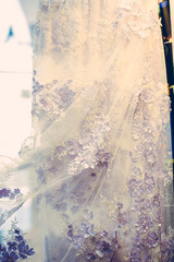 Detail of wedding dress , texture of the material for bride with flowers, vertical vintage