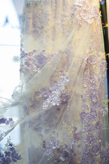 Detail of wedding dress , texture of the material for bride with flowers, vertical