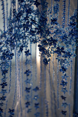 Transparent material of cloth for evening dress for woman, texture with blue flowers