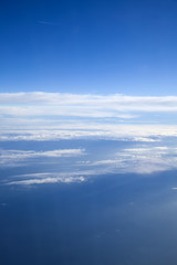 different clouds below, view from a plane
