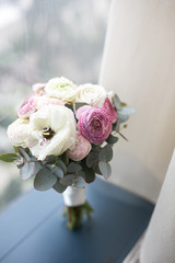 Bouquet of white and pink peonies with greens for woman and bride