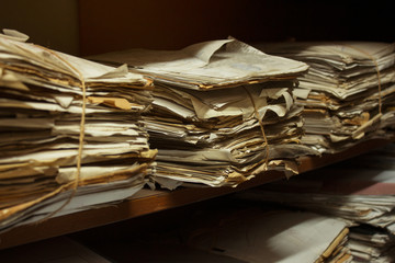 Dusty old stack of papers and files in archive room of office