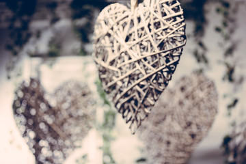 Decoration with hearts made of wooden twigs on the background of