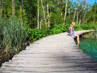 The girl on the walkway over the lake.