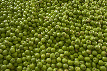 Green and juicy granny smith apple pile at the local farmers mar