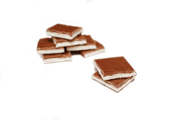 Pieces of milk chocolate with nougat. Vanilla ice cream with milk chocolate. Sweetness. Dessert.