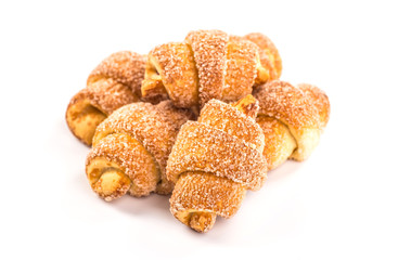 pile of fresh and delicious croissants on a white background