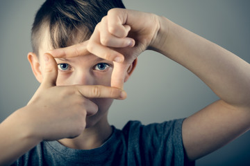 Boy framing with hand