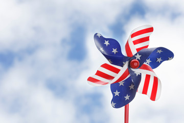 Matte sturdy stars and stripes pinwheel held up on a summery sky