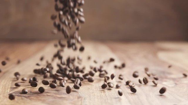 roasted coffee beans falling in slow motion on wood table, 180fps prores footage