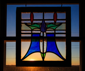Stained glass in window with sunlight behind