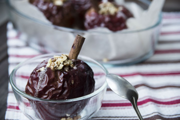 healthy snack in the form of baked red apples with cinnamon and nuts