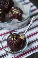 healthy snack in the form of baked red apples with cinnamon and nuts