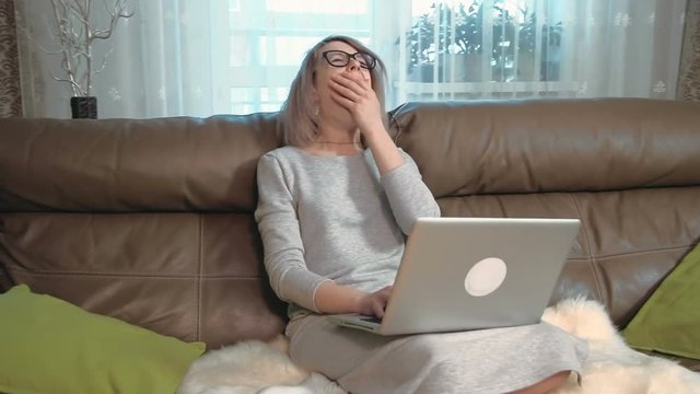 Young businesswoman is tired, she finishes her work and falls asleep