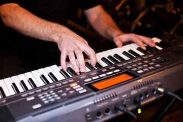 Fototapeta premium Close-up hands of musician who plays keyboards
