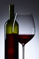 glass and bottle with red  wine