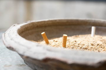Cigarette stubs in ashtray.