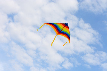 Fototapeta na wymiar Bright, colorful kite on the background of the summer sky