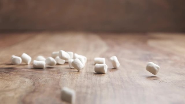white marshmallow falling on wood table in slow motion, 180fps prores footage