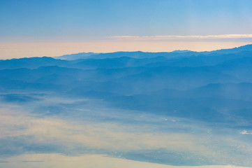 Fototapeta na wymiar Layers of mountain from airplane top view
