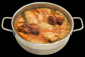 Cabbage Rolls Stuffed With Minced Meat Cooked With Smoked Pork Ribs in Stainless Steel Saucepot Isolated On Black Background