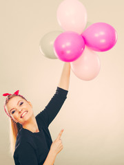 Smiling crazy girl having fun with balloons.