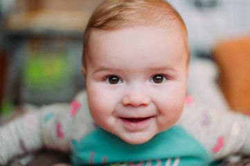 little cute baby toddler on carpet close up smiling adorable happy emotional playing at home