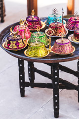 Stack of handmade multicolor Turkish dishes on the market. Vinta