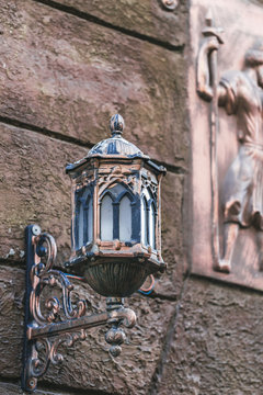 Beautiful old vintage metal lantern on the house wall. Handmade,