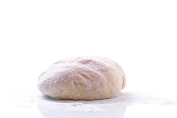 yeast dough with a wooden rolling pin